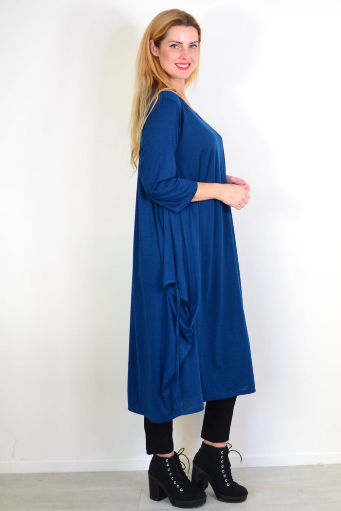 Lilia Whispers teal relaxed oversized tunic dress displayed on a hanger, showcasing its flowy, casual style and soft fabric.