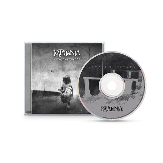 A CD and case for Katatonias Viva Emptiness album, featuring a black-and-white cover image of a child with a teddy bear in an empty, bleak scene that reflects Katatonias signature melodic dark rock style.
