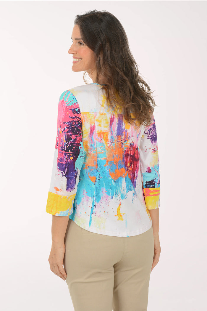 Woman wearing a multicolored 3/4 sleeve top.