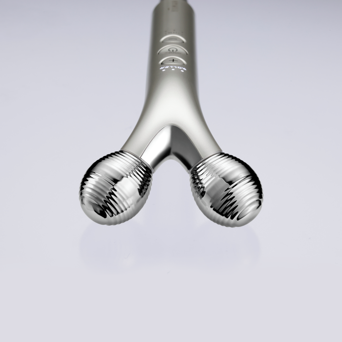 Silver massage tool on a light gray background