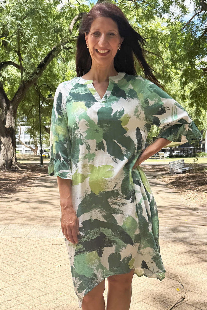 White and green paint splash tunic dress by Ruby Rain, featuring a relaxed fit and artistic design, displayed on a mannequin.