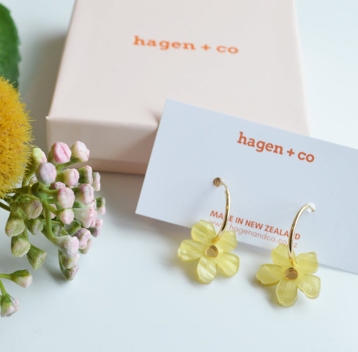 Pink gift box and yellow Wildflower Earrings on a white display card and flowers - ANNIE.G