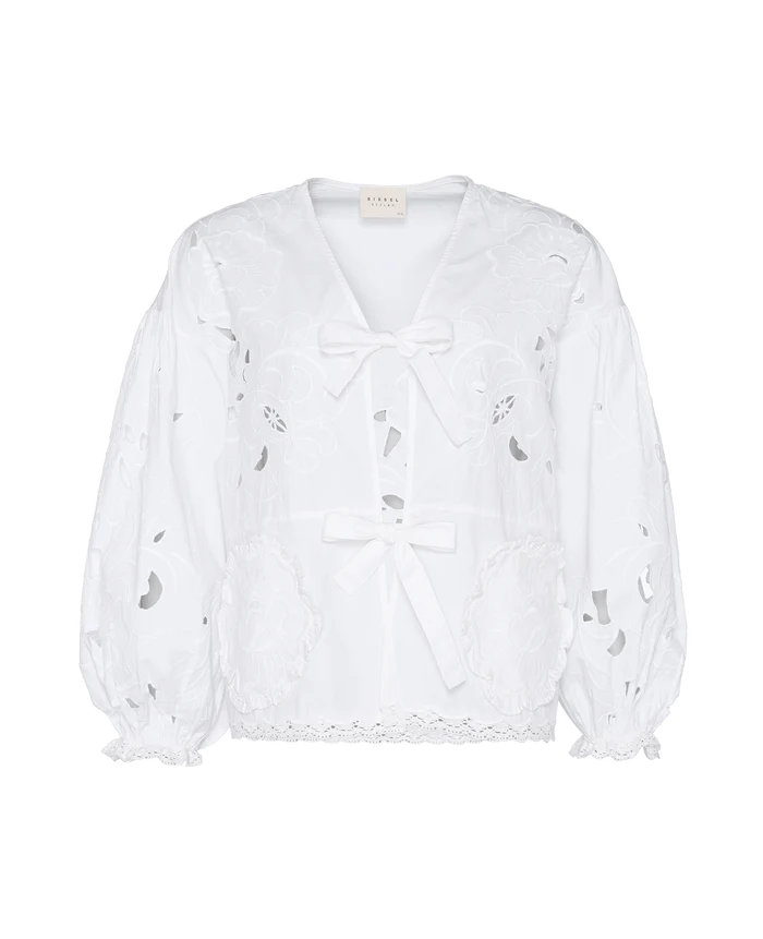 Front of white top with long sleeves and front ties with cutwork embroidery.