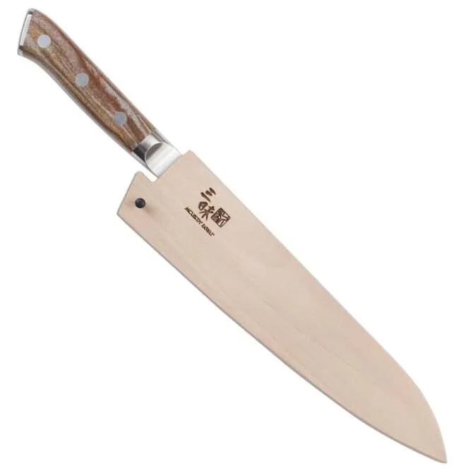 A Zanmai Pro Gyuto SE knife with a distinctive handle pattern and a natural wood saya cover.