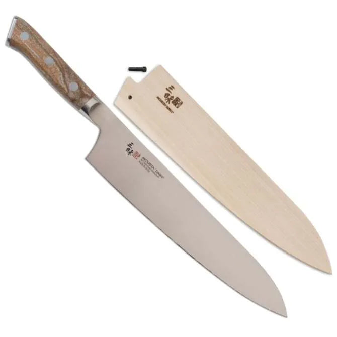 A Zanmai Pro Gyuto SE knife with a distinctive handle pattern and a natural wood saya cover.