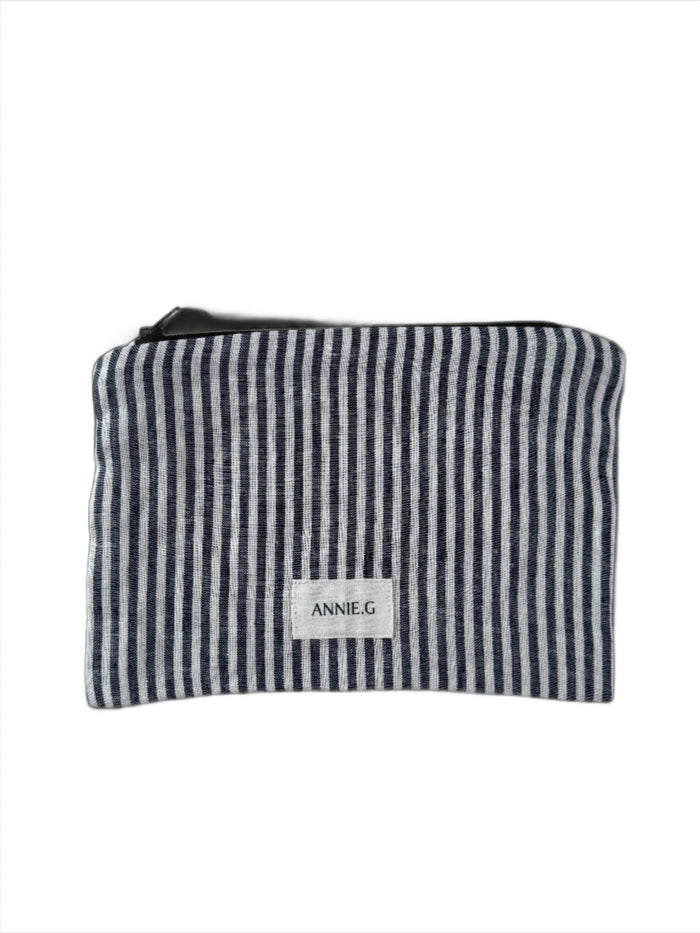 Navy and white striped zip top pouch with ANNIE.G brand label sewn on the front.