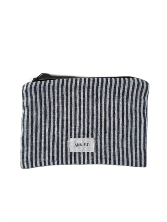 Navy and white striped zip top pouch with ANNIE.G brand label sewn on the front.