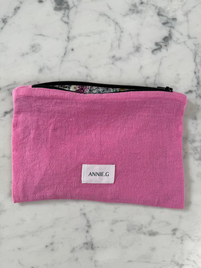 Pink zip top bag with floral lining and ANNIE.G brand tag sewn on the front - ANNIE.G